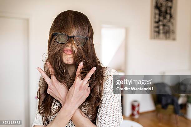 playful young woman at home - viso nascosto foto e immagini stock