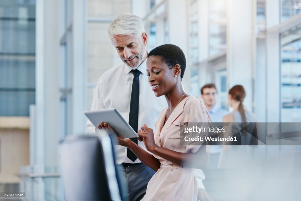 Businessman and businesswoman with digital tablet