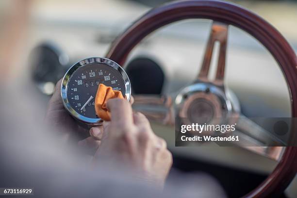 senior man polishing tachometer of a car - vintage car stock pictures, royalty-free photos & images