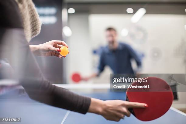 two colleagues playing table tennis in office break room - table tennis fotografías e imágenes de stock