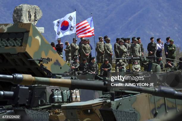 South Korea and US soldiers watch from an observation post during a joint live firing drill between South Korea and the US at the Seungjin Fire...