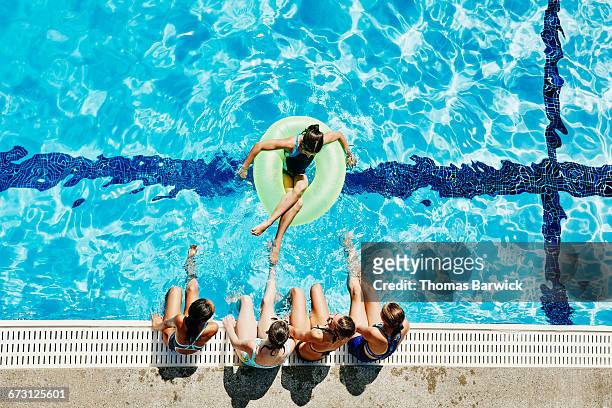 group of girls hanging out together at pool - tube girl fotografías e imágenes de stock