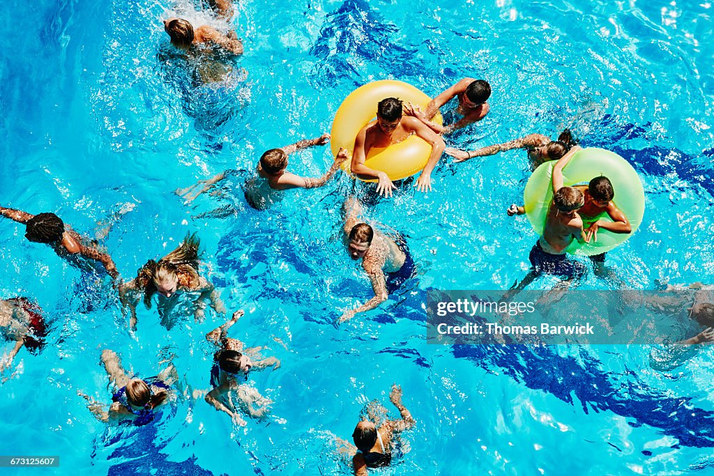 Group of kids playing together in outdoor pool
