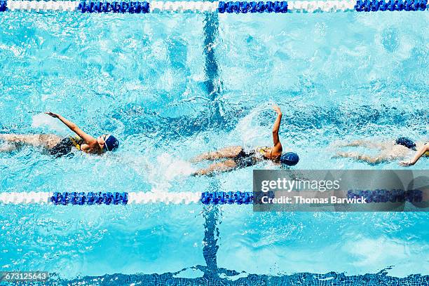 young female swimmers practicing in outdoor pool - niño bañandose fotografías e imágenes de stock