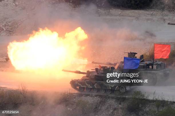 South Korean K1A2 tank and a US M1A2 tank fire live rounds during a joint live firing drill between South Korea and the US at the Seungjin Fire...