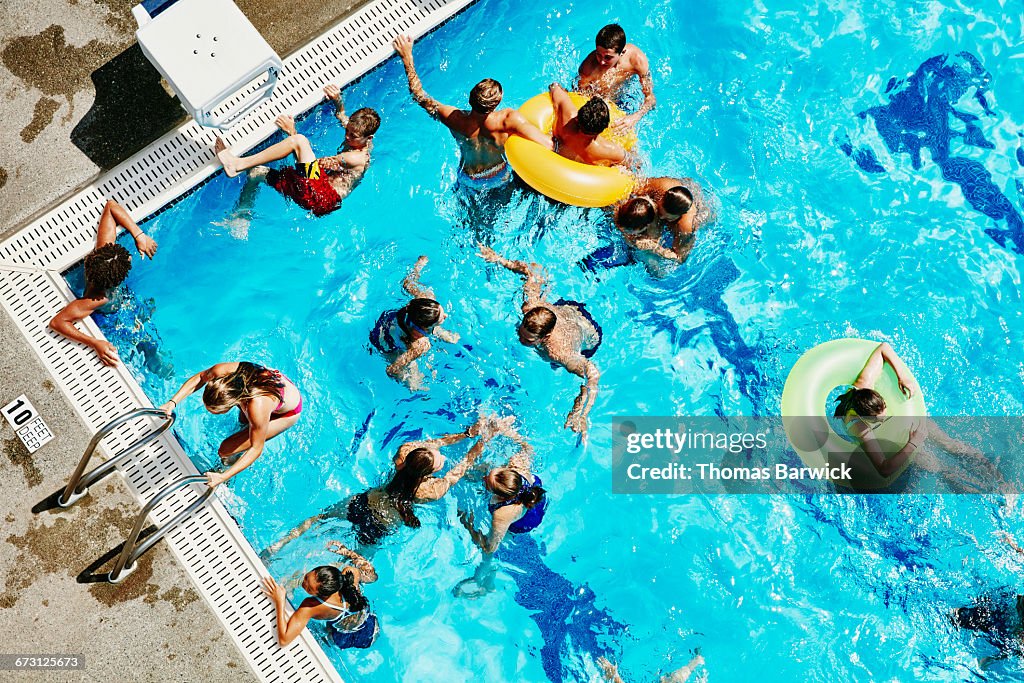 Group of friends playing together in outdoor pool