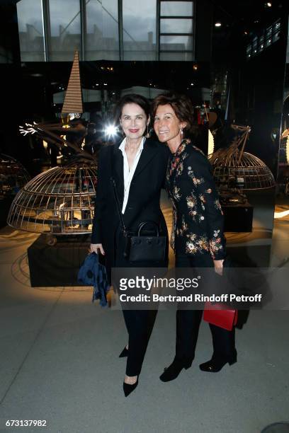 Dayle Haddon and Sylvie Rousseau pose in front the works of Jean-Paul Goude during the "Societe des Amis du Musee d'Art Moderne du Centre Pompidou" :...