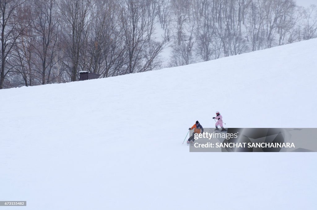 People Skiing On Snow Covered Field