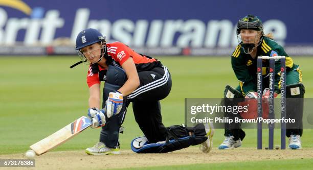 England batsman Sarah Taylor hits out watched by Australia's Jodie Fields during the Women's quadrangular T20 cricket match at the County Ground in...