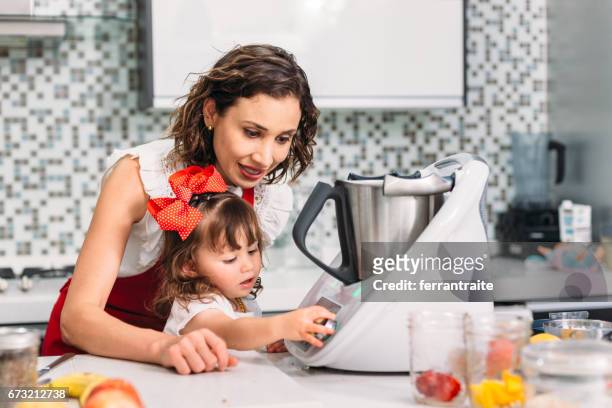 mother and daughter cooking together - food processor stock pictures, royalty-free photos & images