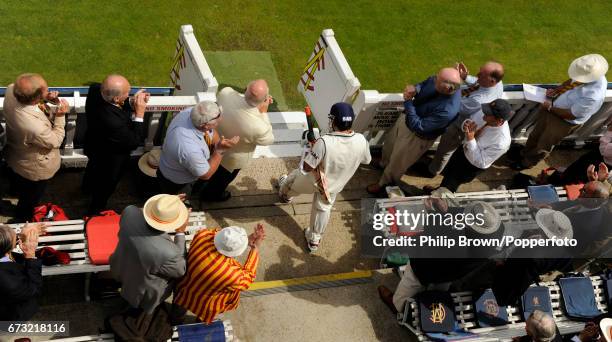 India's Sachin Tendulkar walks through the MCC members' seating area on his way on to the field for his innings during the 1st Test match against...