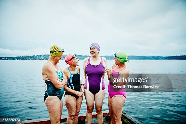 laughing swimmers preparing for morning swim - 50 59 years stock pictures, royalty-free photos & images