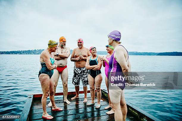 Laughing swimmers on dock before morning swim