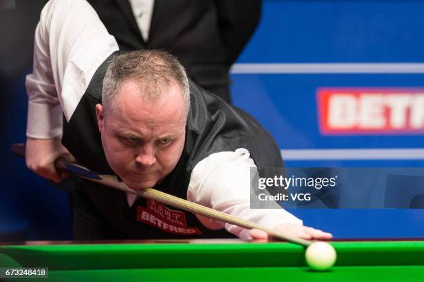 John Higgins of Scotland plays a shot during his quarter-finals match against Kyren Wilson of England on day twelve of Betfred World Championship...