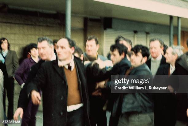 30th January 1972. A civilian, shot and wounded by British paratroopers, is rushed to a waiting ambulance. Soldiers opened fire on the civil rights...