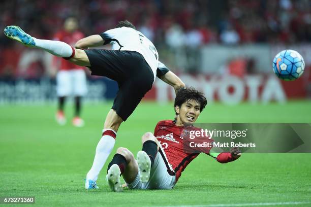 Yosuke Kashiwagi of Urawa Red Diamonds competes for the ball against Scott Neville of Western Sydney Wanderers during the AFC Champions League Group...