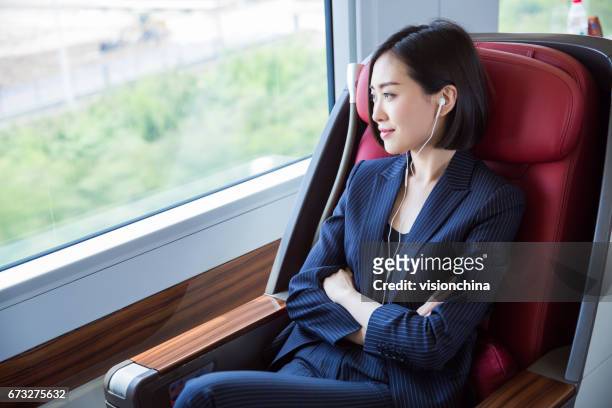 shot of beautiful business woman sitting inside high-speed train,shanghai,china. - walkman closeup stock pictures, royalty-free photos & images