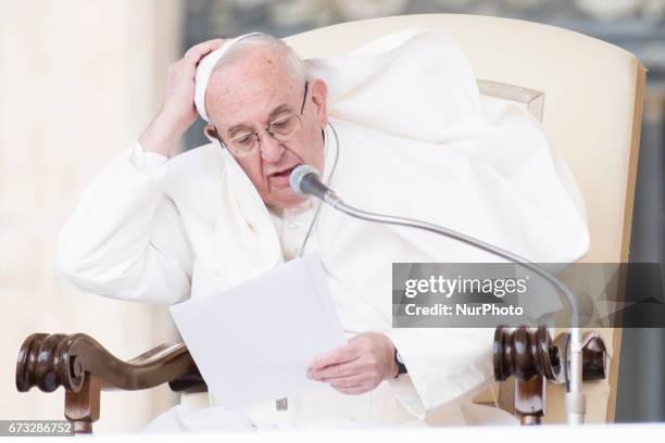 Gust of wind blows the mantle of Pope Francis as he delivers his speech during his weekly general audience in St. Peter square at the Vatican,...