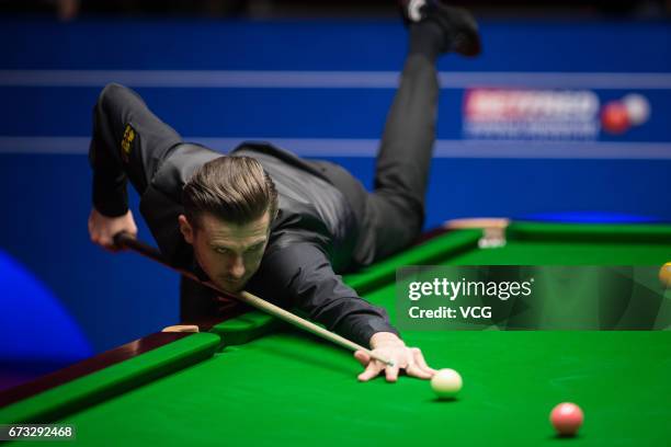 Mark Selby of England plays a shot during his quarter-finals match against Marco Fu of Chinese Hong Kong on day twelve of Betfred World Championship...