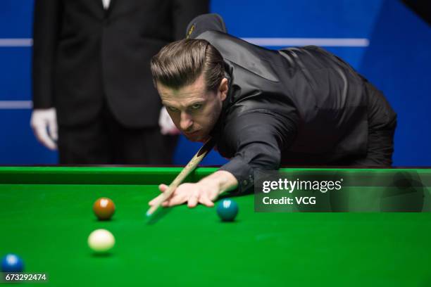 Mark Selby of England plays a shot during his quarter-finals match against Marco Fu of Chinese Hong Kong on day twelve of Betfred World Championship...