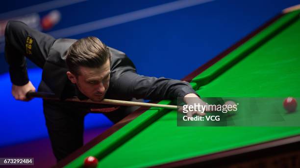 Mark Selby of England plays a shot during his quarter-finals match against Marco Fu of Chinese Hong Kong on day twelve of Betfred World Championship...