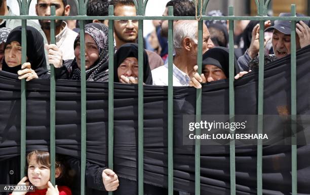 Syrian mourners attend a funeral ceremony in the Sayyida Zeinab mosque on the outskirts of Damascus on April 26 for the victims of a bombing that...