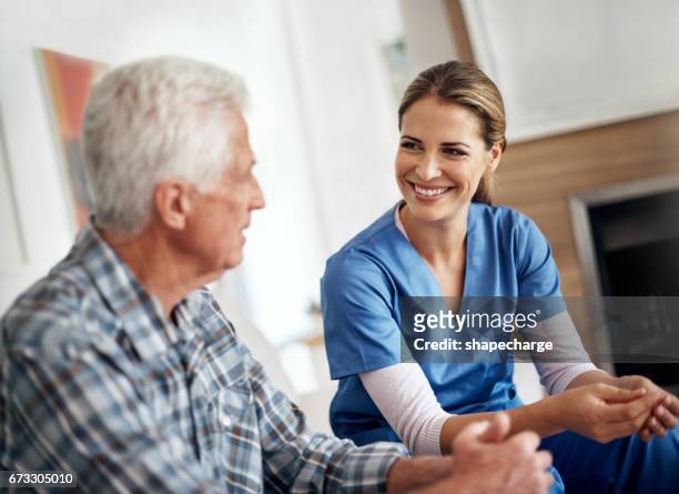 caregivers care about more than just your health - nurse candid stock pictures, royalty-free photos & images