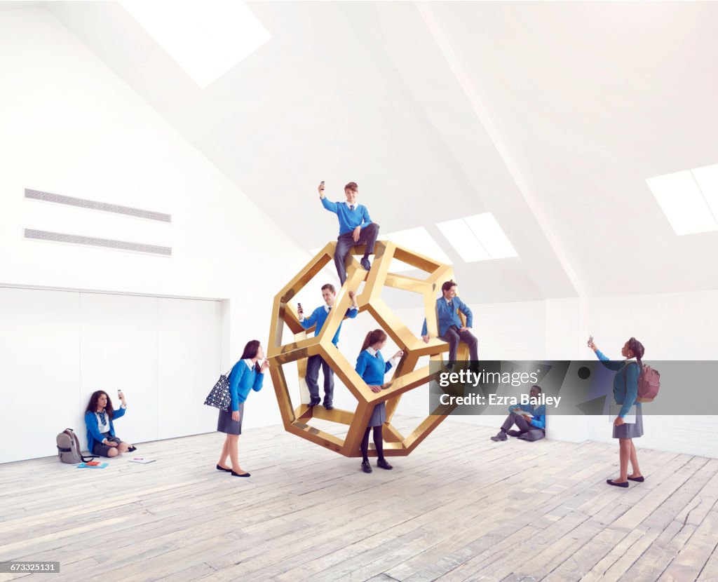 School kids interacting with an impossible shape.