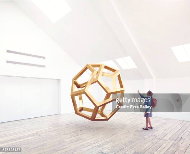 school girl taking a photo of an impossible shape - museum sculpture stock pictures, royalty-free photos & images