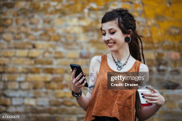 portrait of hipster young woman using smart phone for communication - alternative lifestyle stock pictures, royalty-free photos & images