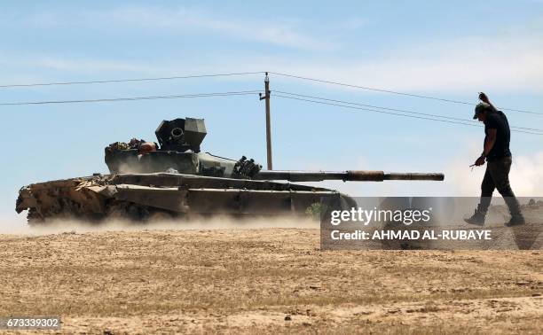 An Iraqi-modified T-72M tank belonging to the pro-government Hashed al-Shaabi paramilitary forces advances towards the UNESCO-listed ancient city of...