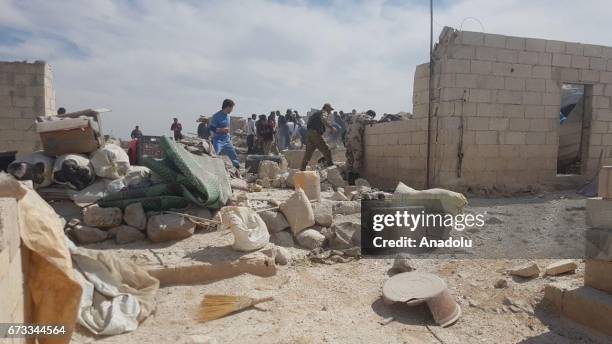 Syrians inspect the debris after unidentified war crafts carried out airstrikes over refugee camp at the eastern districts of Maarat al-Numan in...