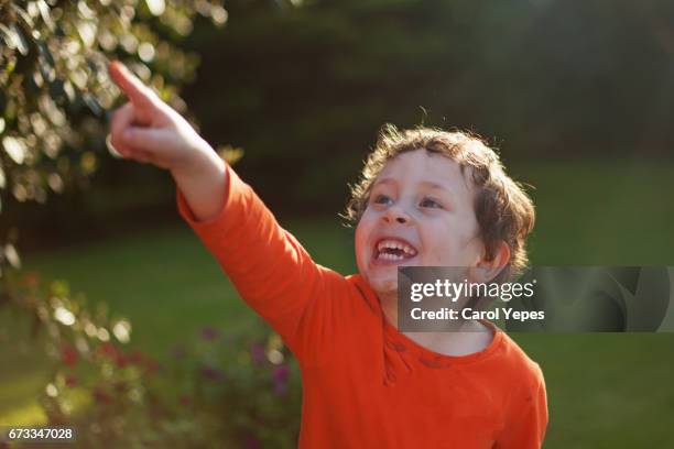 happy smiling boy pointing  up - child pointing stock pictures, royalty-free photos & images