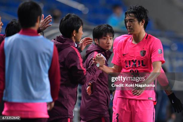 Mu Kanazaki of Kashima Antlers shakes hands with Kashima Antlers Head Coach Masatada Ishii after his substitution during the AFC Champions League...