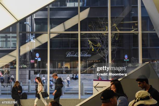 Shoppers and pedestrians pass in front of a Brooks Brothers Group Inc. Store in New York, U.S., on Thursday, April 13, 2017. Bloomberg is scheduled...