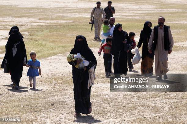 Displaced Iraqi families evacuate from the modern town of Hatra and neighbouring villages, near the eponymous UNESCO-listed ancient city, southwest...