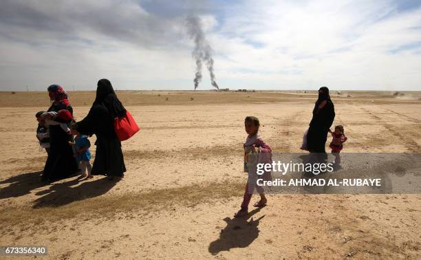 Displaced Iraqi families evacuate from the modern town of Hatra and neighbouring villages, near the eponymous UNESCO-listed ancient city, southwest...
