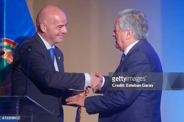 President Gianni Infantino and President of Chilean National Football Association Arturo Salah shake hands during the 67th CONMEBOL Congress at...
