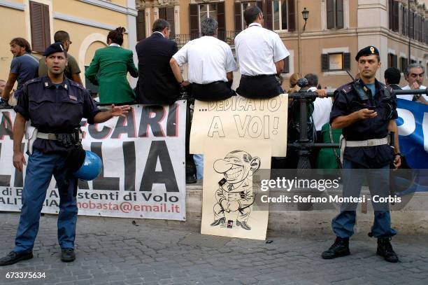 Air hostesses and employees of Italy's flag carrier Alitalia demonstrate in front of the Italian Prime Ministry, the Palazzo Chigi. Banner read:...