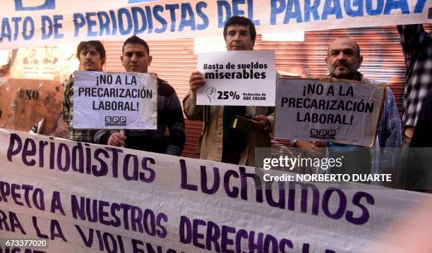 Reporters demonstrate outside the Paraguayan Labor Ministry demanding higher salaries, greater job security and improved safety conditions on...