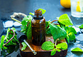 Mint essential oil in bottle .Fresh peppermint leaves with essential oil, alternative medicine