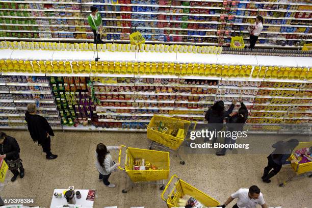 Customers view products for sale at an Almacenes Exito SA store in Bogota, Colombia, on Thursday, April 20, 2017. The Foundation for Higher Education...