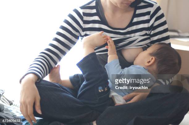 mother and son breast milk - adult eating no face stock pictures, royalty-free photos & images