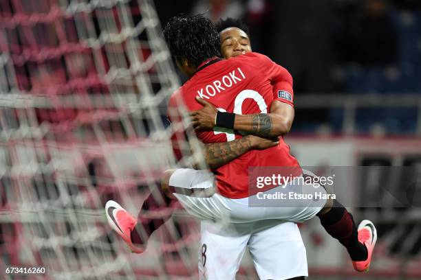 Shinzo Koroki of Urawa Red Diamonds celebrates scoring his team's sixth goal with his team mate Rafael da Silva during the AFC Champions League Group...