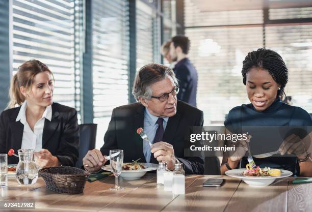 business people in a cafe restaurant on a lunch break - working lunch stock pictures, royalty-free photos & images