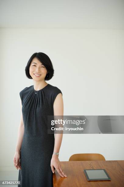 business life - woman wearing black dress stock pictures, royalty-free photos & images