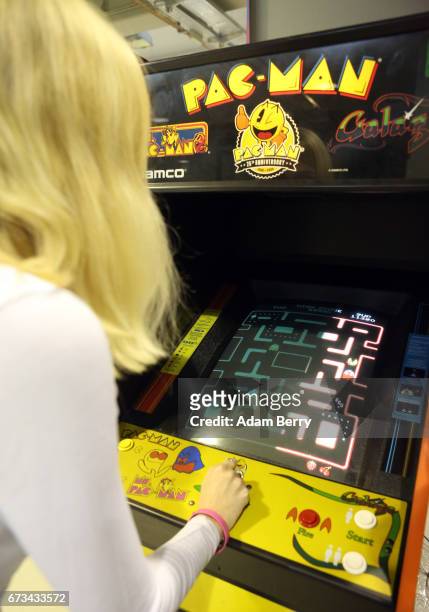 Visitor Alina Ullrich plays a vintage Pac-Man video game at the Making Games conference during International Games Week on April 26, 2017 in Berlin,...