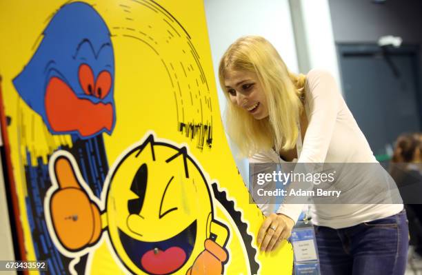 Visitor Alina Ullrich plays a vintage Pac-Man video game at the Making Games conference during International Games Week on April 26, 2017 in Berlin,...