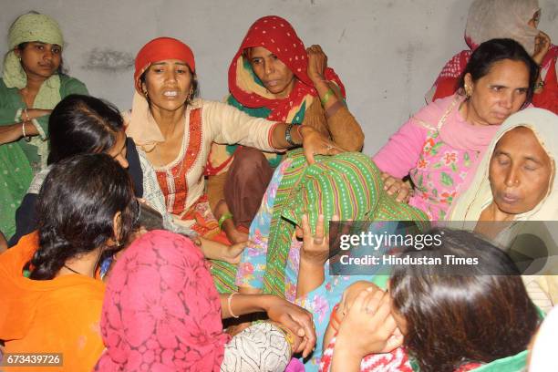 Family members of Sukma Martyr CRPF ASI Naresh Kumar mourning during the funeral at his native village Jainpur Tikola on April 26, 2017 in Sonepat,...