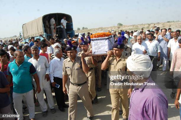 Sukma Martyr CRPF ASI Naresh Kumar's terrestrial body carried by CRPF personnel at his native village Jainpur Tikola on April 26, 2017 in Sonepat,...